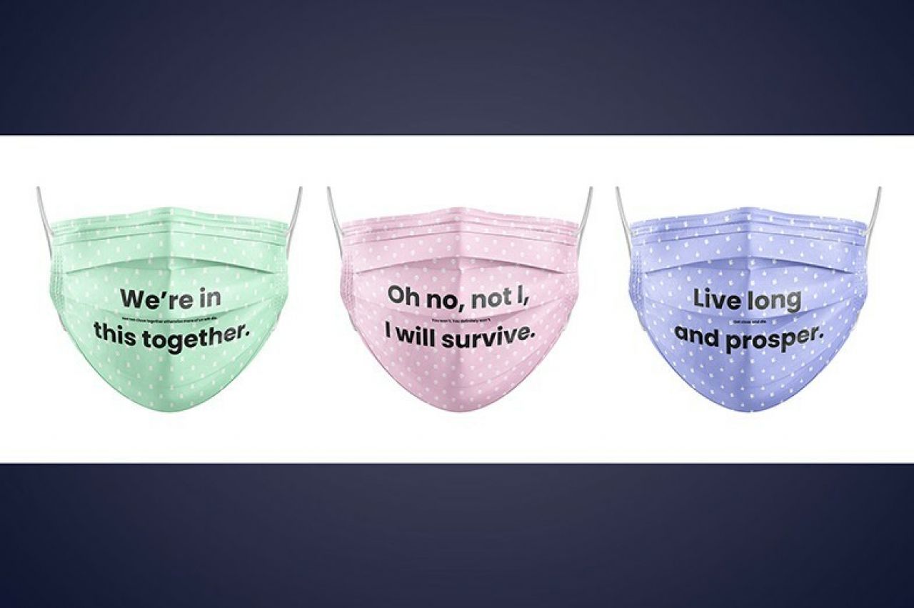 Green, pink, and purple facemasks with social distancing slogans.