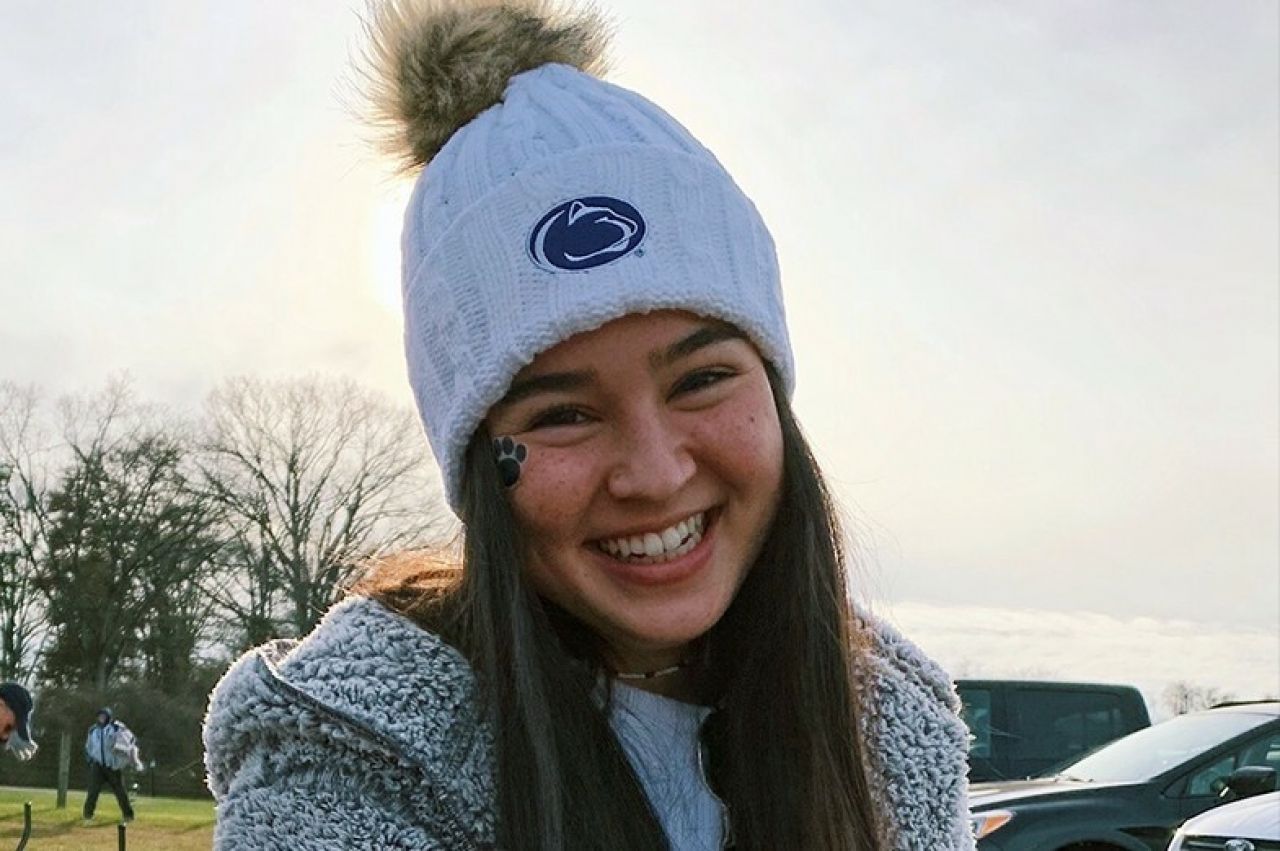 Kimi Mate with a white Penn State winter hat on her head.