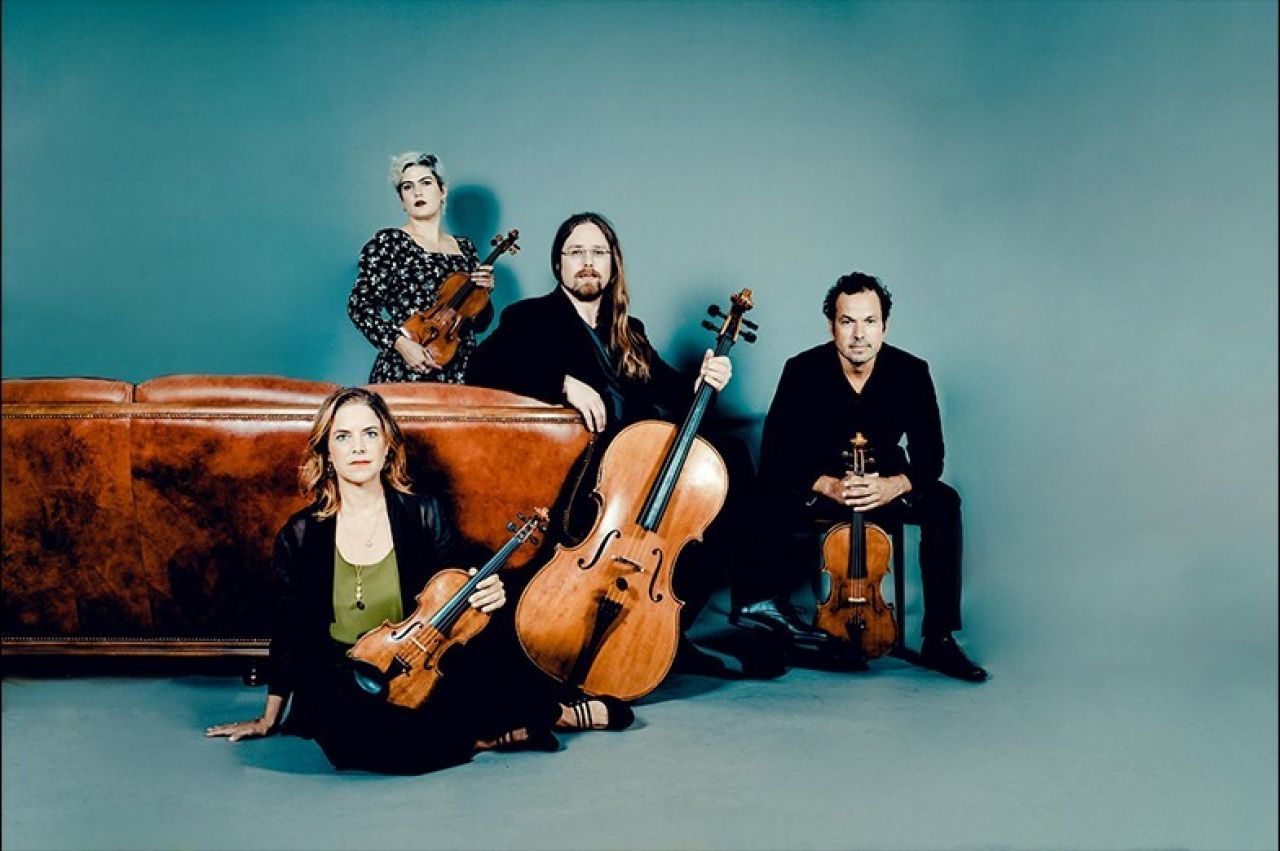 portrait of four members of Mivos Quartent with stringed instruments