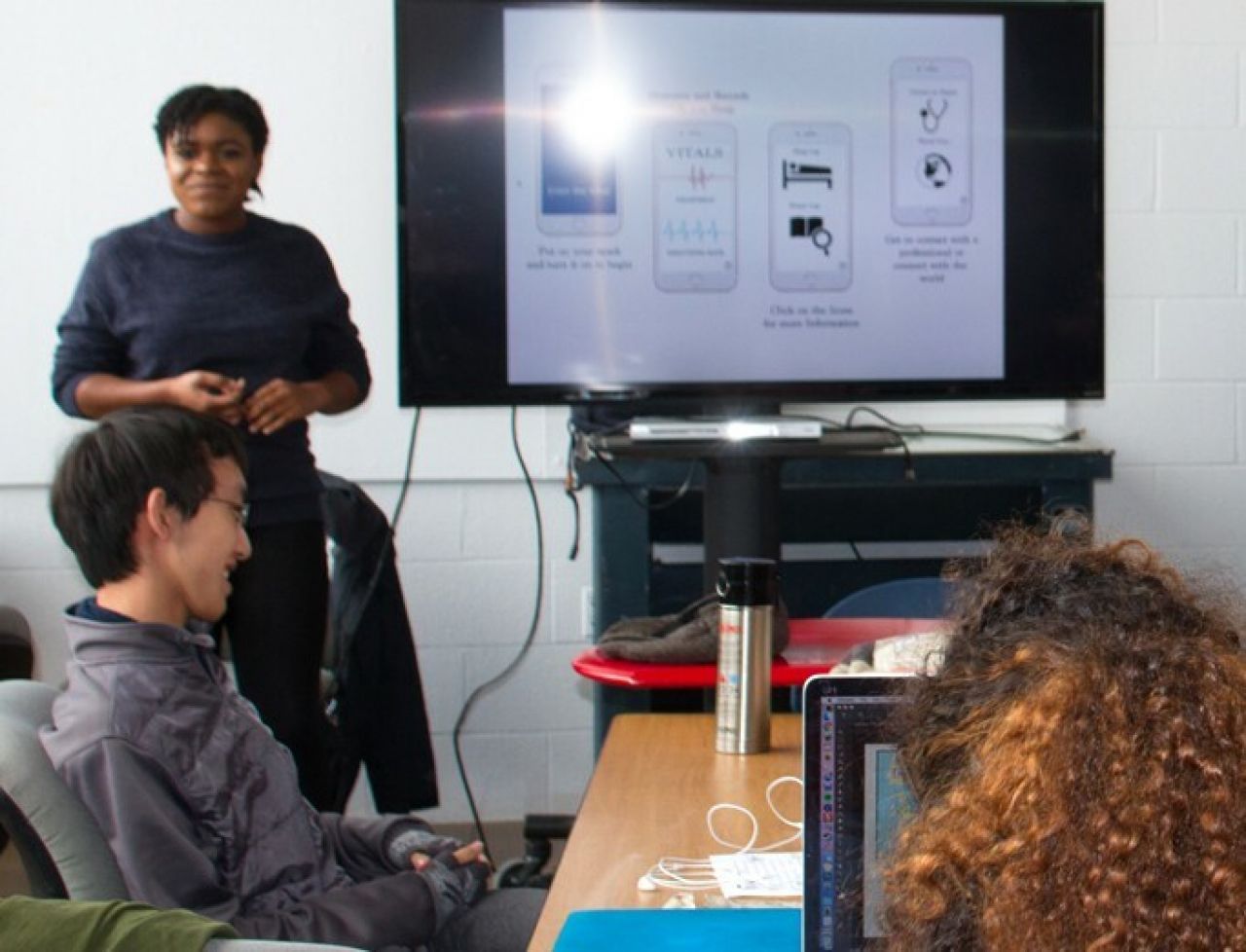 SoVa students in class discussing a digital application.