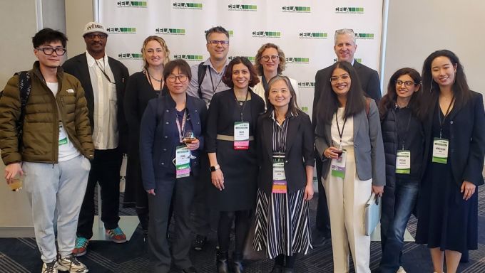 A group of faculty members and students pose in front of a Council of Educators in Landscape Architecture backdrop.