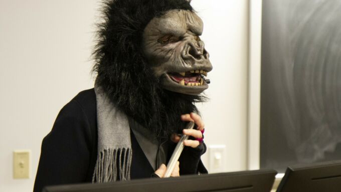 Masked Guerrilla Girl giving lecture