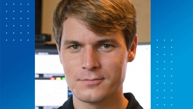 White man with light brown hair smiling