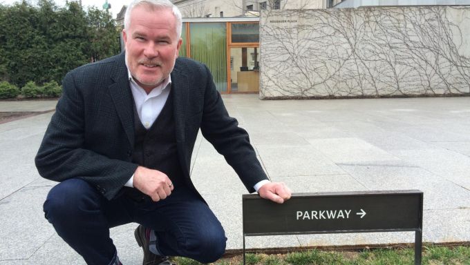 Paul Daniel Marriott poses next to a parkway sign.