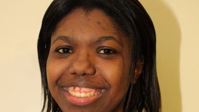 Head shot of a young Black woman smiling