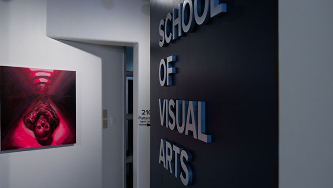 Art gallery with the words "School of Visual Arts" on a wall.