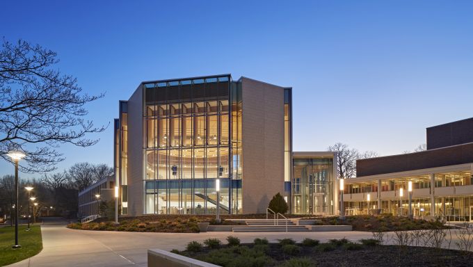 Large building with grand windows being photographed and dusk