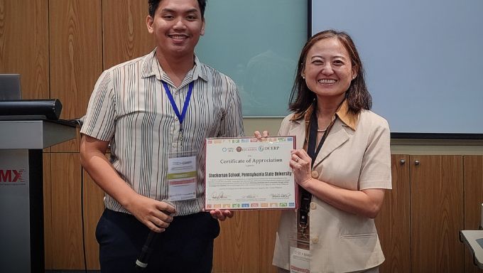 Chingwen Cheng at right accepts a certificate from a leader of the Association of Pacific Rim University Sustainable Cities and Landscapes at left.