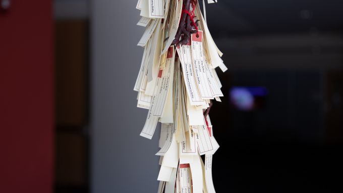 Slips of paper attached to a pole