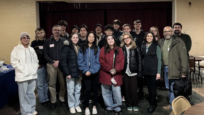 A group of students and instructors pose for a photo.