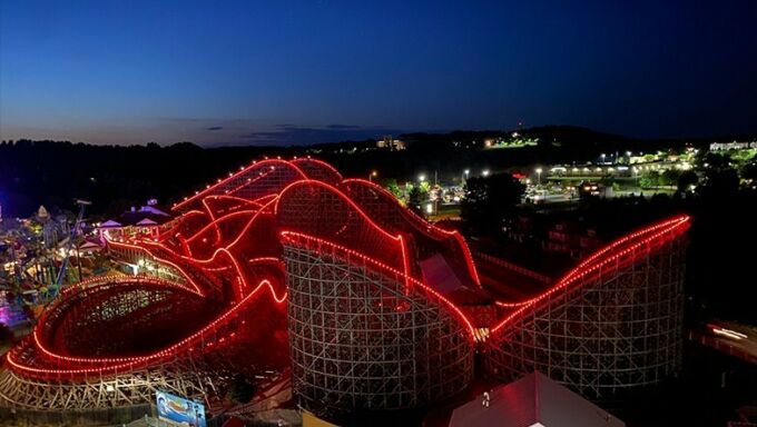 drone photo of a roller coaster with red lights lining the track