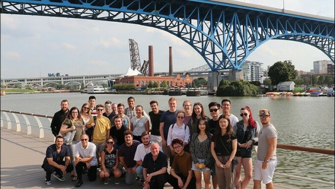 Group of students and faculty members pose under a bridge in Cleveland, Ohio.