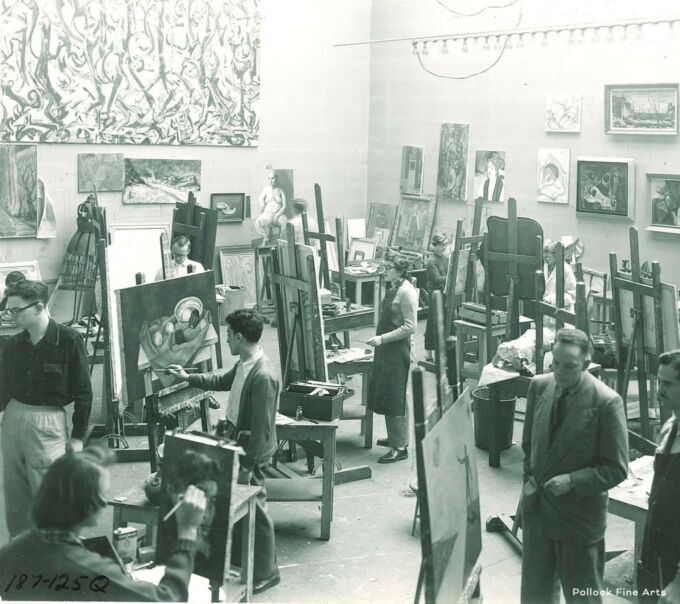 Students painting in large room with paintings on the wall, circa 1950s