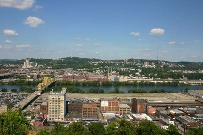 The appearance of the neighborhood urban forest cover of the Strip District and East Pittsburgh, PA, is pictured as seen from Bedford Hill looking toward the David McCullough Bridge
