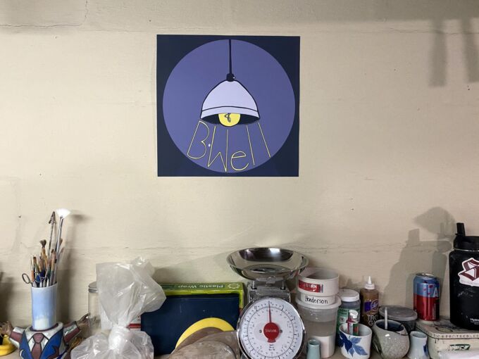 "Be Well" sign in basement studio