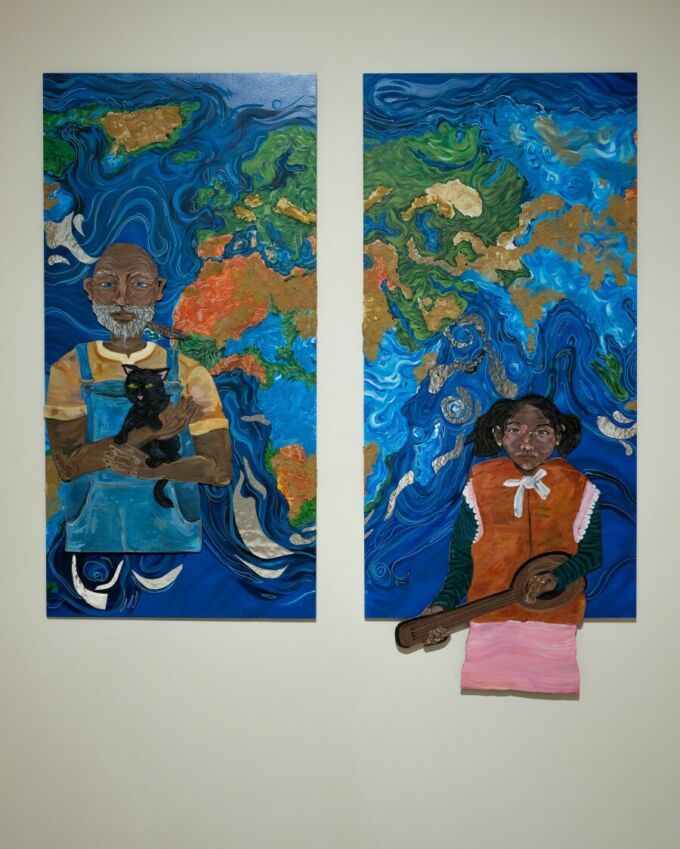 Two paintings on display of two people against a stylized background of Earth’s continents and oceans.
