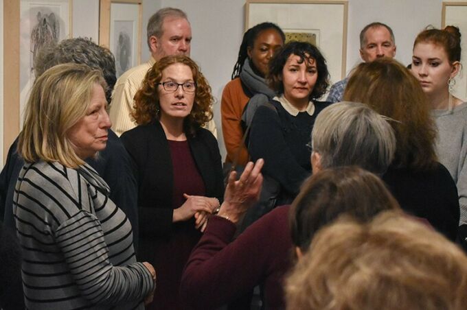 Cathy Braasch stands in the center of a group visitors to the Palmer Museum gallery talk.