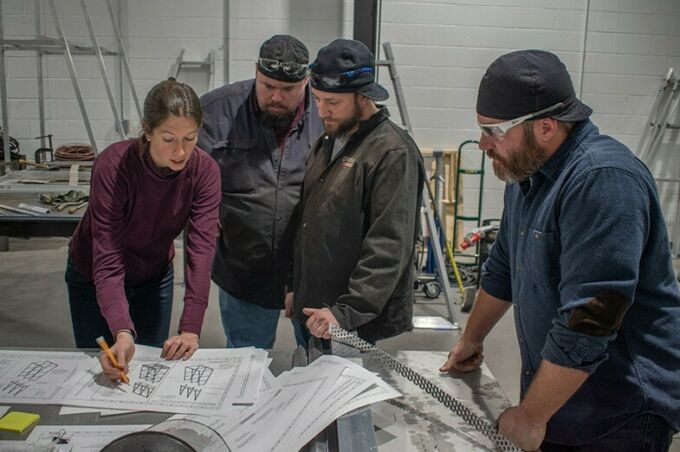 Gillean Denny meets with three Penn College welding and fabrication faculty members over plans.