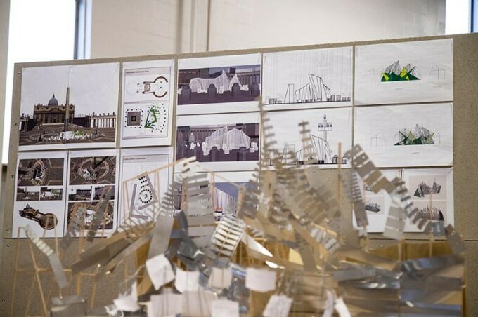 Plans for the Living Chapel are pinned up in the background as a model of the structure is in the foreground.