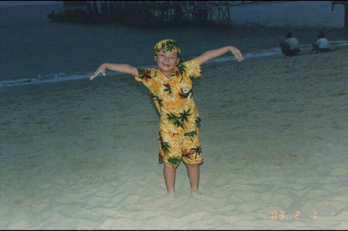 Yiwei Leo Wang at age 4 posing funnily in front of the beach