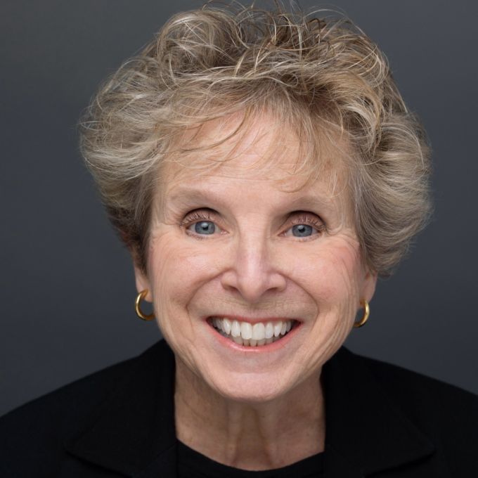 Older white woman with blonde hair smiling