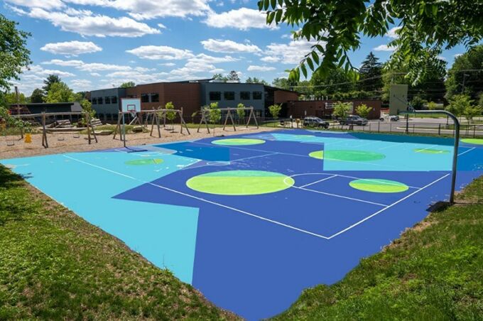 Vibrant green and blue geometric shapes painted on a basketball court