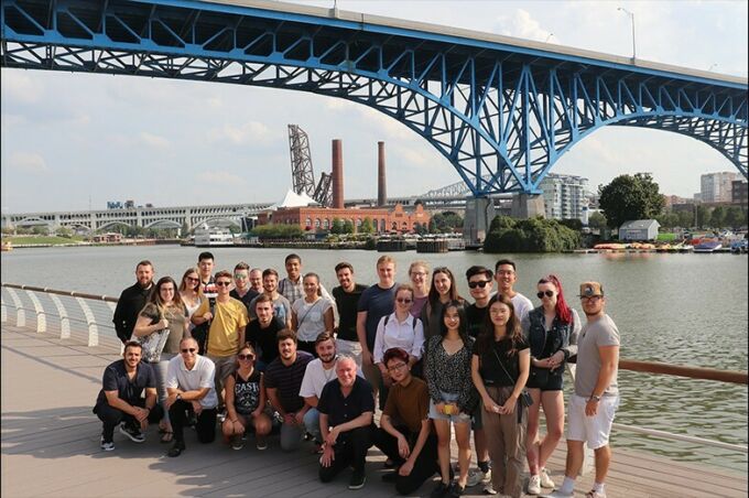 Group of students and faculty members pose under a bridge in Cleveland, Ohio.