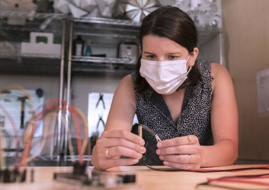 Elena Vazquez doing research in the Stuckeman Center for Design Computing in a face mask.