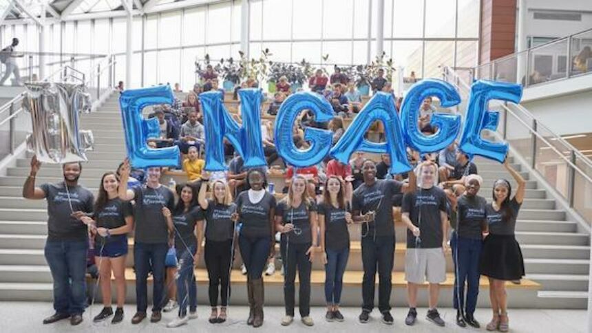 Students holding balloons that spell ENGAGE
