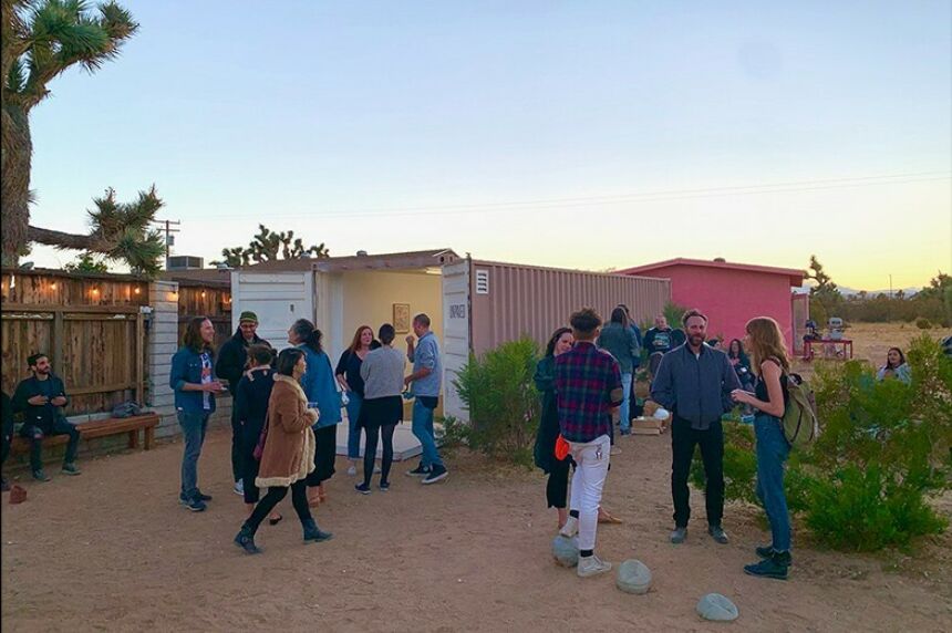 People milling around the opening reception for Biophilia at Unpaved Gallery in the desert.