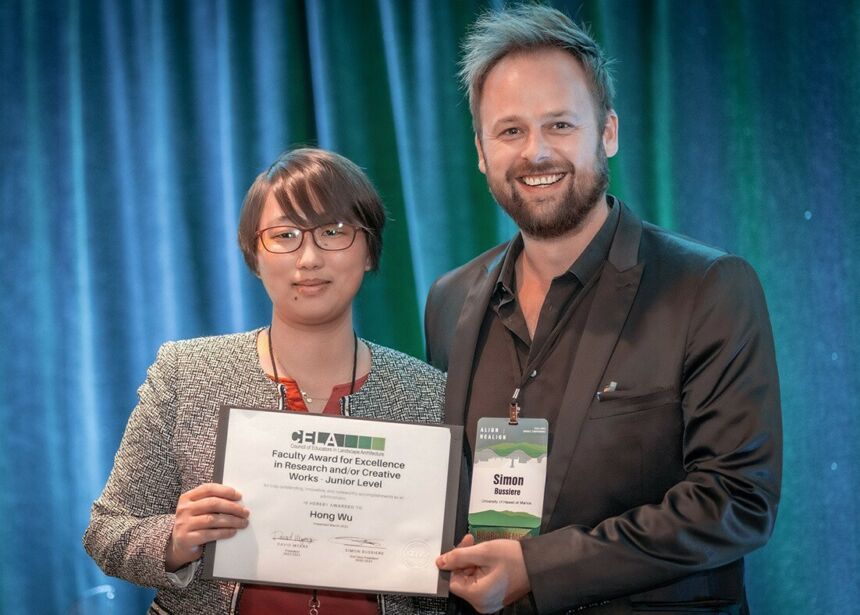 Hong Wu, at left, accepts her 2023 Excellence in Research and/or Creative Work Award from Simon M. Bussiere, second vice president of the Council of Educators in Landscape Architecture.