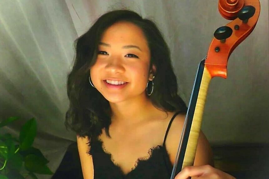 Music graduate Annabelle Lecy holding her cello