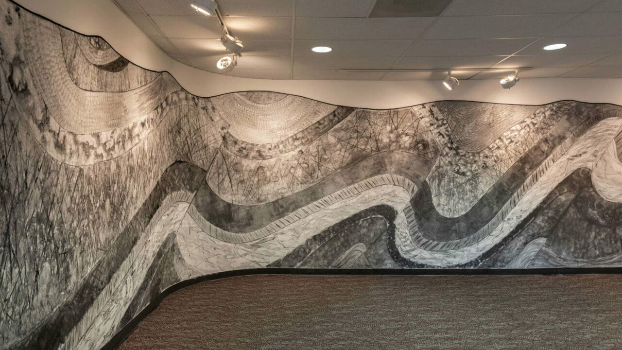 Panoramic charcoal illustration of central Pennsylvania's landscape on a curved wall.