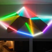 Multi-color neon light fixture hanging on Woskob Family Gallery's wall.