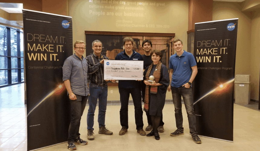 Penn State NASA Mars Challenge team standing together holding large prize check