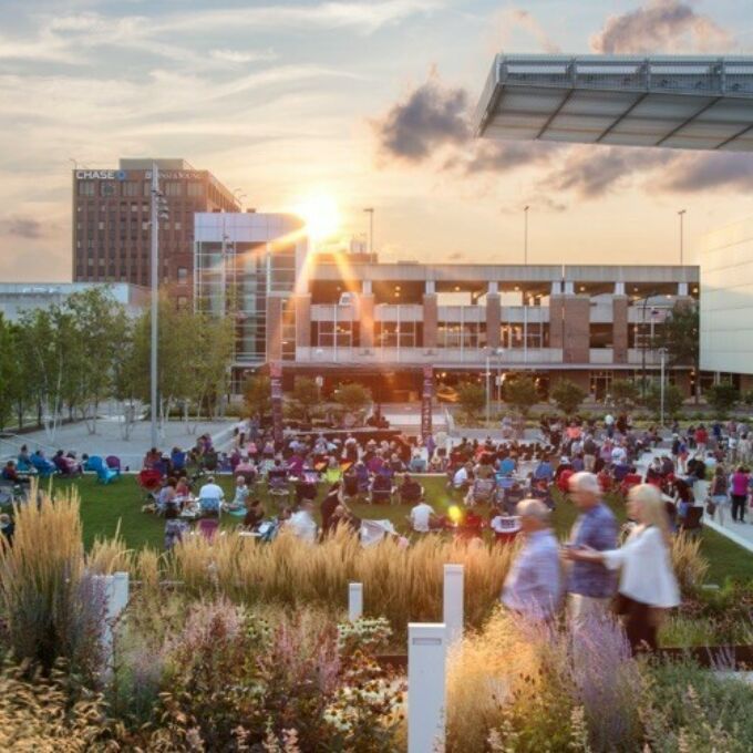 Large group of people enjoying a sunset gathering in an urban landscape architecture design by Demetrios Staurinos.