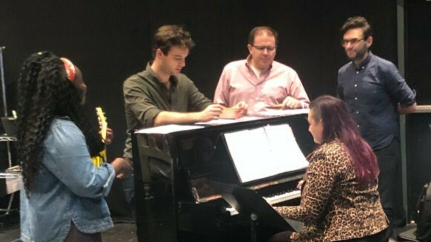 Students around a piano, working alongside Simpkins and playwright Joe Iconis.