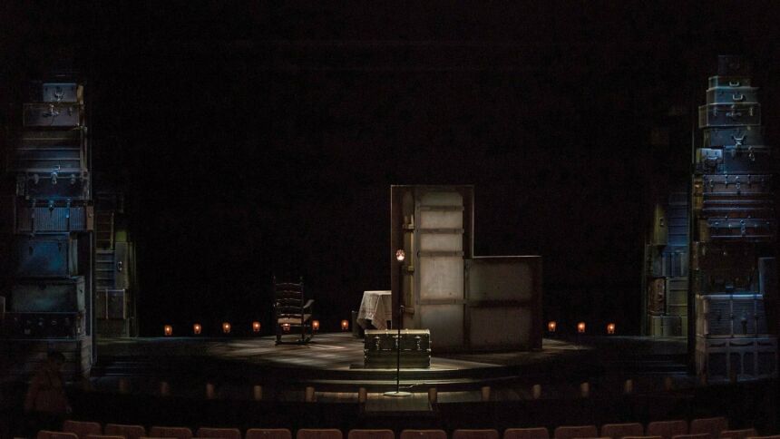 "Gypsy," Scenic Design of a table and chair flanked on both sides by stacked trunks.