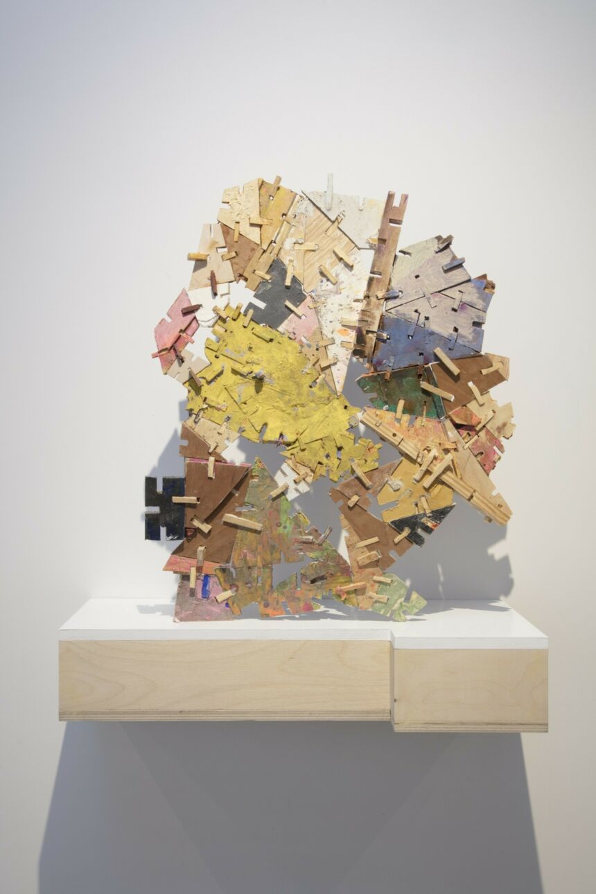 Abstract multi-colored mixed media art installation consisted of many fragmented pieces of wood.