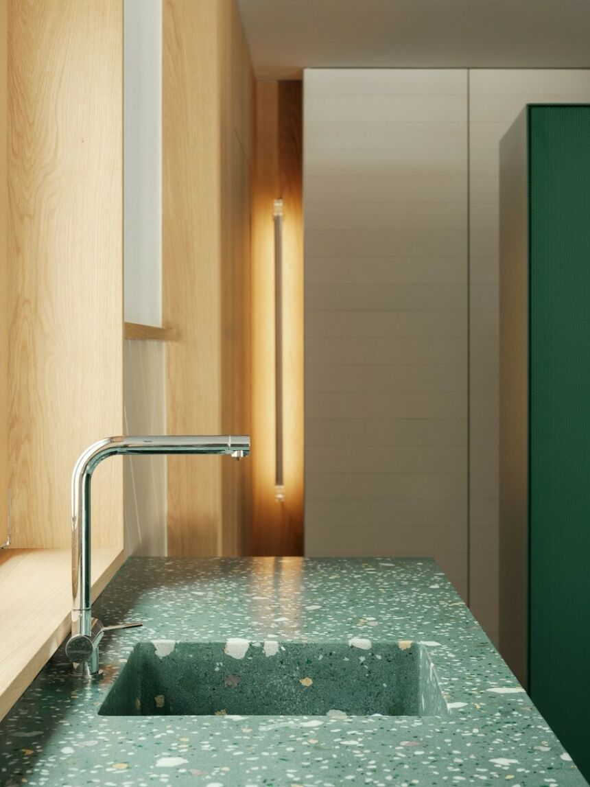 A side view of a faucet with a marbled green countertop.