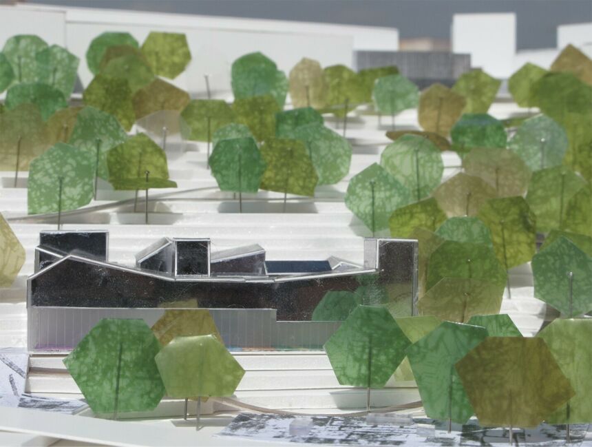 A model featuring geometric green trees surrounding a built structure.