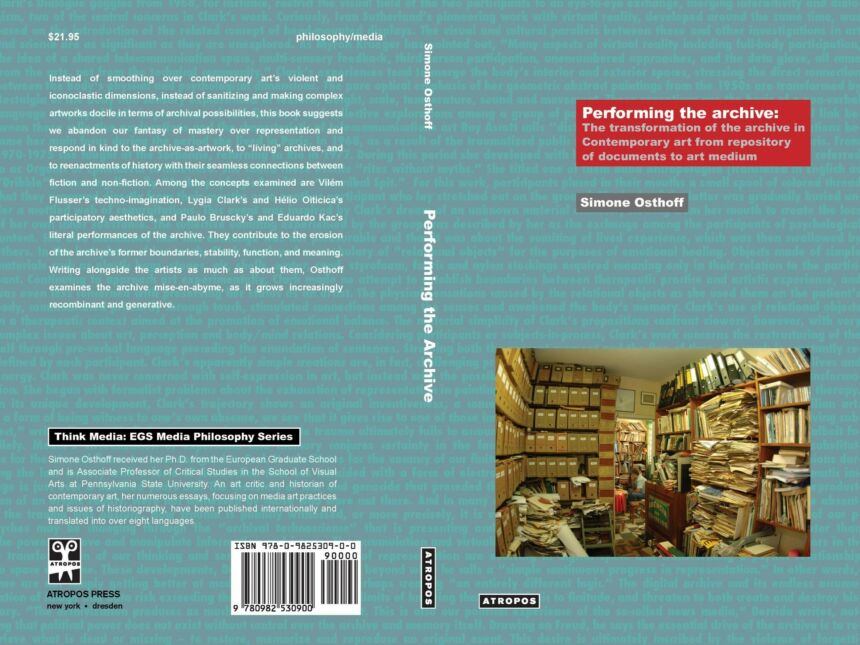 Teal book cover with overlaid blue text; features photo of room packed with shelving of files and books with a man sitting in the far end.
