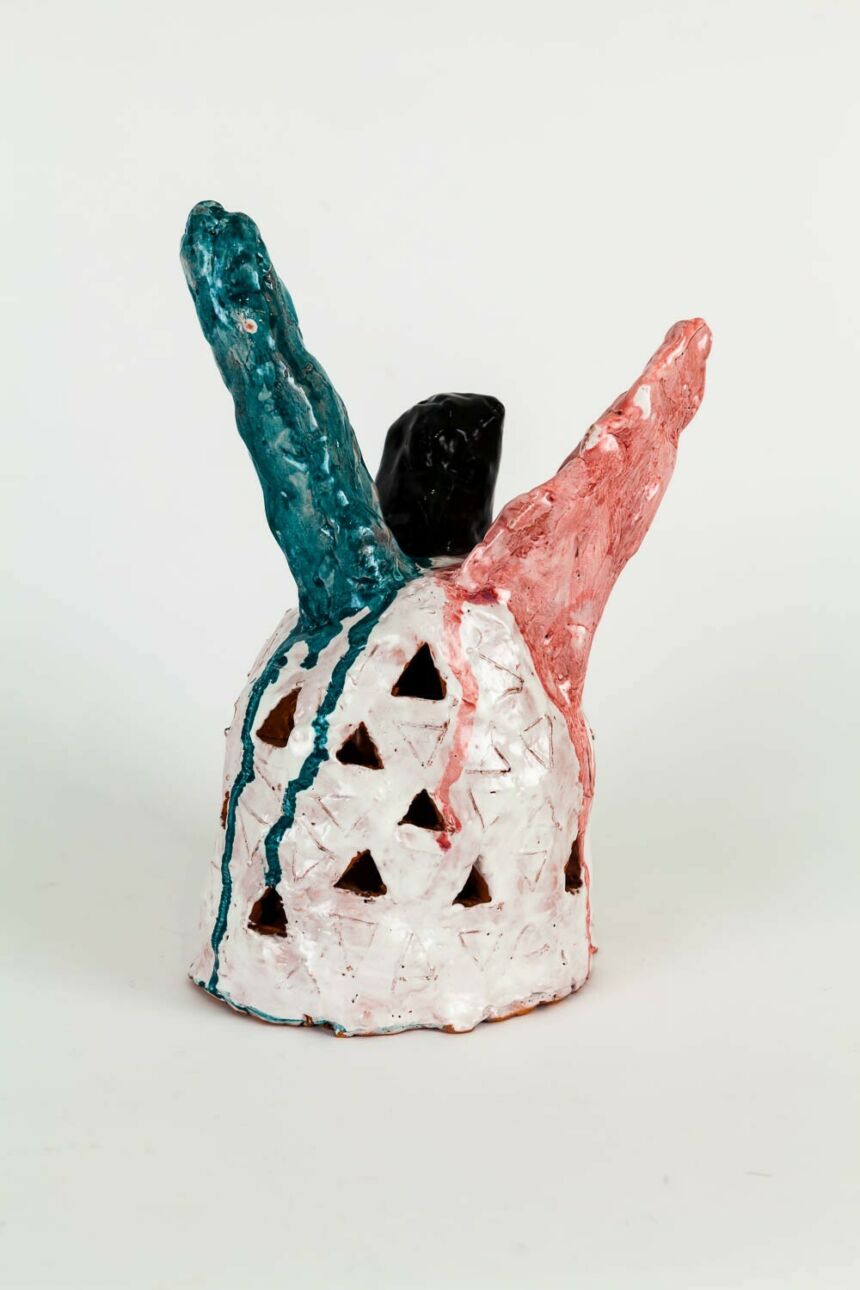 White, black, teal, and pink abstract sculpture.