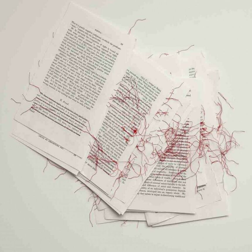 Red threading is stitched across various lines of text on several scattered loose pages.