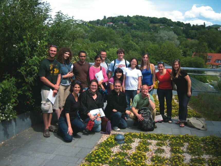 Group photo of Lisa Iulo and her students in front of green hillside while on a class trip in Freiburg, Germany.