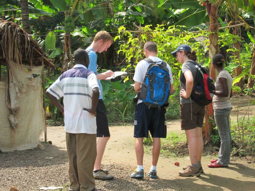 Photo of visiting students collaborating with locals outdoors.