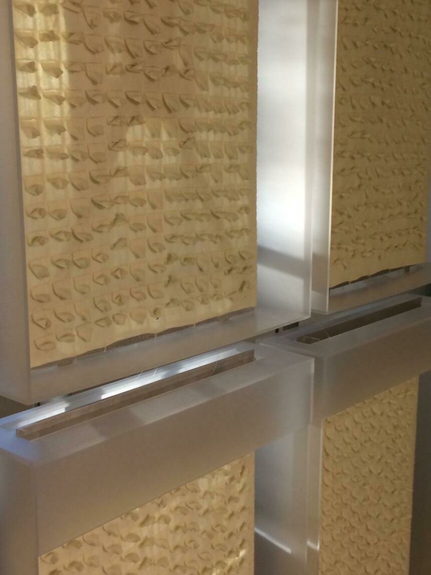 Close-up photo of fabric panels suspended in metal frames.