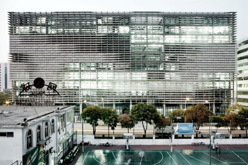 Exterior photo of the side of Lafayette 148 Headquarters. A secondary building with adjoined basketball courts are in the foreground.