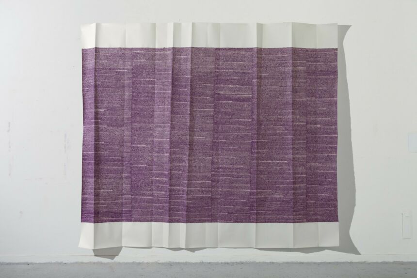 Photo of a large scale purple painting on folded paper.