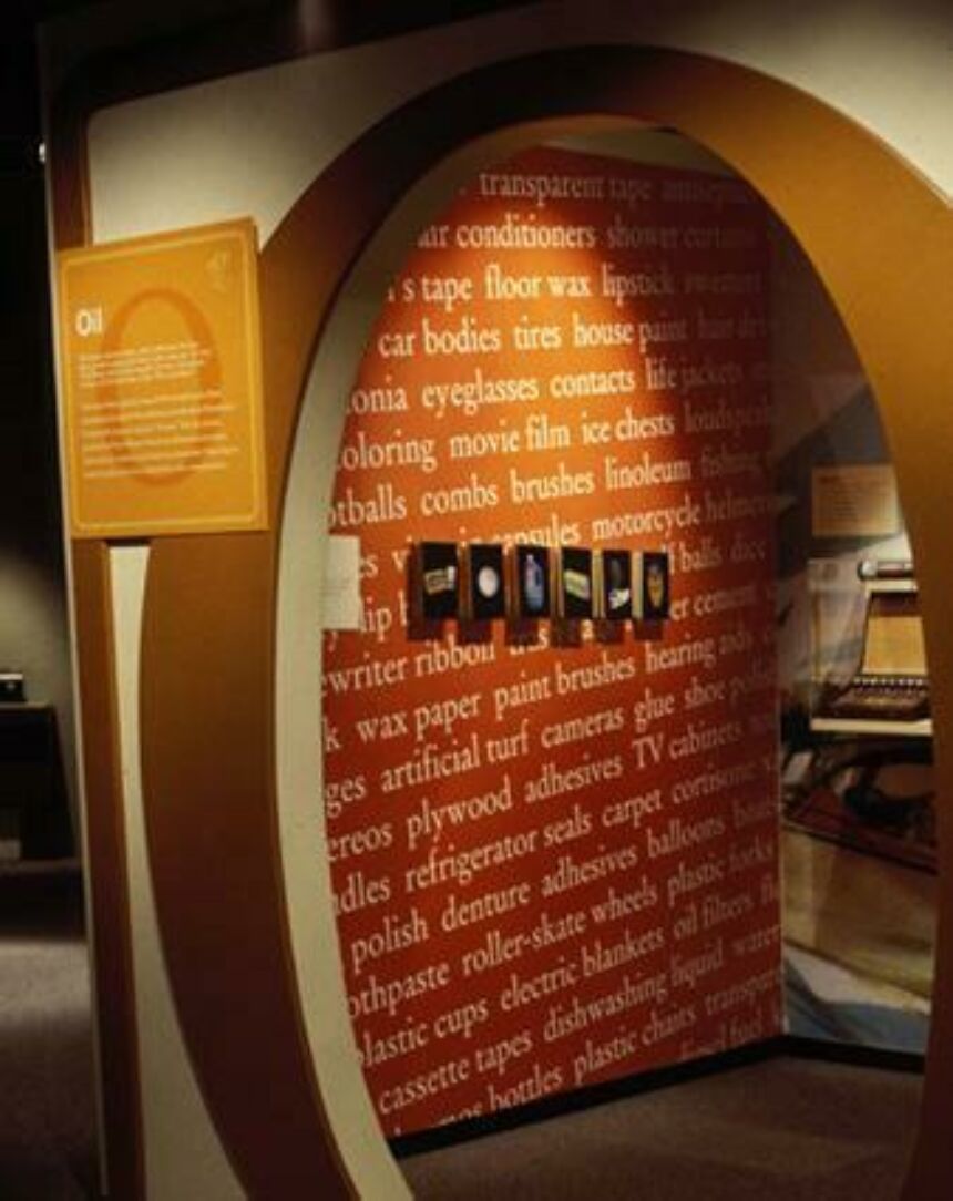 Interior photo of an archway framed by a giant "O", with a wall of text behind it.